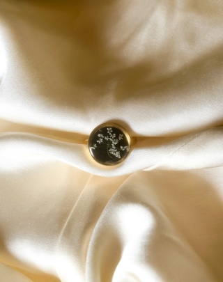 Pierścionek z żywicy z czarnym tłem i białymi kwiatuszkami